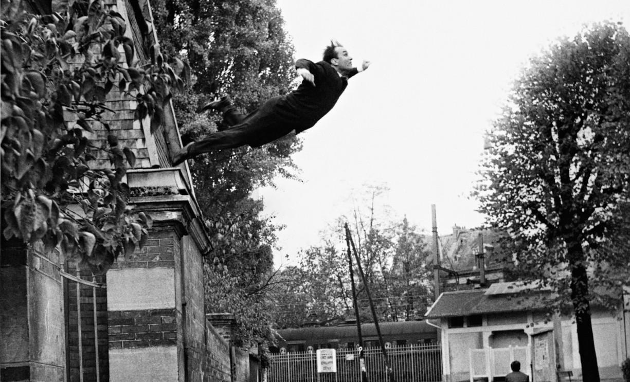 Un homme s’élance du haut d’un pilier, visage tourné vers le ciel, bras en croix. Il semble chuter et s’envoler à la fois.